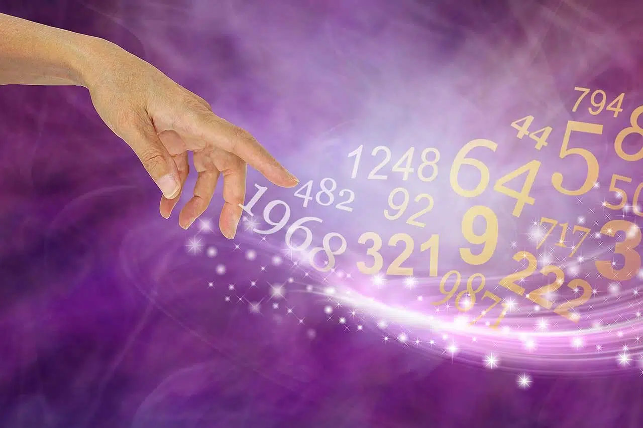 Female hand appearing to create a swish of sparkles and a flow of random numbers on a pink purple energy formation background